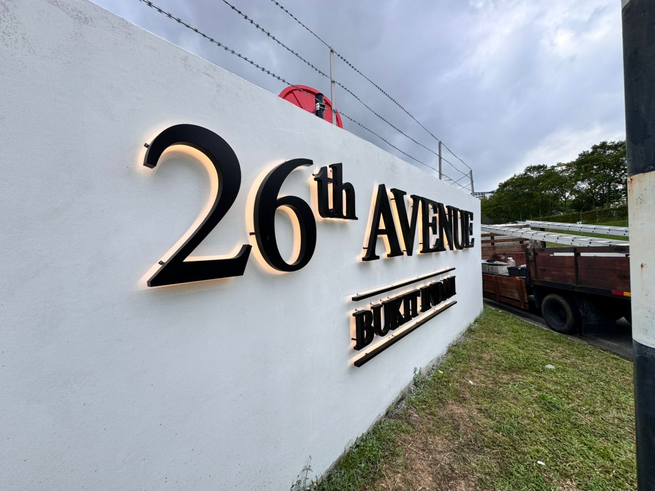 26th Avenue Bukit Indah architectural wall sign with warm halo-lit 3D letters